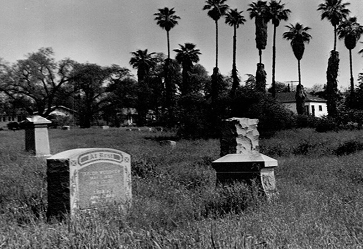 An abandoned cemetery in Whittier, CA with overgrown headstones and unkept grounds in the 1960s, long overdue for attention.